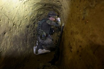A serviceman of the 13th Khartiia Brigade of the National Guard of Ukraine participates in the construction of underground communication trenches for an observation post, July 11, 2026.
