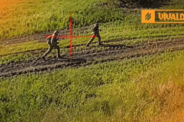 Two Russian soldiers cross an open field under a targeting reticle during Ukraine’s 3rd Army Corps Operation Vivaldi. (Source: 3rd Army Corps)