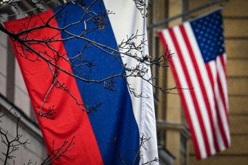 A Russian flag waves in front of a US flag seen at the US Embassy in Moscow on December 15, 2025. (Source: Getty Images)
