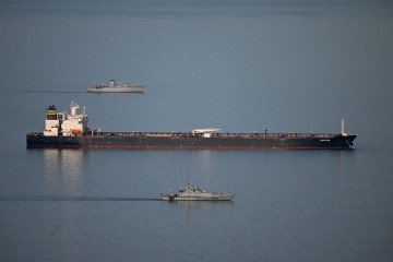 Military ships patrol the Smyrtos vessel outside the harbour, on June 14, 2026 in Portland, England. An oil tanker operating as part of Russia’s shadow fleet has been intercepted by British Forces in the English Channel. (Source: Getty Images)