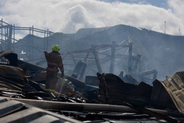 Ukrainian firefighters are working at a destroyed warehouse following a recent Russian drone strike in Kyiv region on September 22, 2026. (Source: Getty Images)