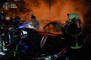 Firefighters extinguish burning civilian vehicles in Kyiv following an overnight Russian drone and missile attack on September 24. (Source: Kyiv State Emergency Service)