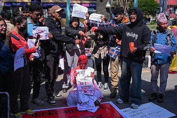 Activists in Kathmandu spatter red powder symbolizing blood to demand the release of the government’s inquiry report on Nepal’s September 2025 youth uprising. (Source: Getty Images)