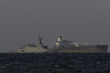 A Venezuelan navy patrol boat escorts a Panamanian-flagged crude oil tanker Yoselin near the El Palito refinery in Puerto Cabello, Venezuela, on November 11, 2025. (Source: Getty Images)