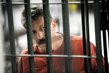 Russia’s “Merchant of Death” Viktor Bout Is Back in the Arms Business Alleged Russian arms dealer Viktor Bout looks on as he stands behind bars