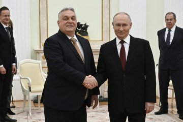 Russian leader Vladimir Putin and Hungary's Prime Minister Viktor Orban shake hands during a meeting at the Kremlin in Moscow on November 28, 2025. (Source: Getty Images)