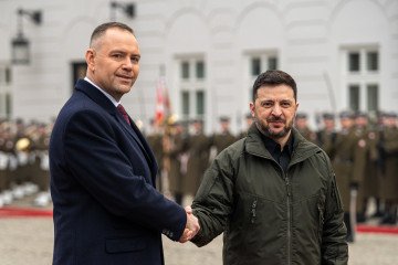 Karol Nawrocki, Poland's president, left, welcomes Volodymyr Zelenskiy, Ukraine's president, at the Presidential Palace in Warsaw, Poland, on December 19, 2025. (Source: Getty Images)