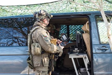 A member of Lithuania’s specialized 1031st Drone Company operates a Ukrainian-made “Chuyka” drone detector next to a mobile command van during tactical field exercises. (Source: Lithuania’s specialized 1031st Drone Company)