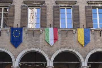 Flags of the European Union, Italy, and Ukraine displayed on Modena’s town hall in solidarity with Ukraine in Modena, Emilia Romagna, Italy. (Source: Getty Images)