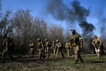 Recruits, supervised by instructors, cover a distance on Day Zero of Basic Military Training at the 118th Separate Mechanised Brigade of the Ukrainian Armed Forces on April 5, 2026. (Source: Getty Images)