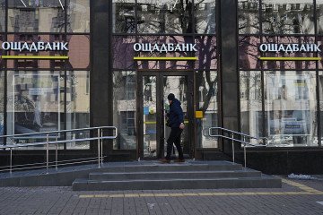 A man enters an office of Oschadbank, in the city of Kyiv on March 6, 2026. (Source: Getty Images)