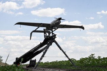 A technician launches a Ukrainian Raybird UAV from a catapult during an aerial reconnaissance mission by soldiers of the 148th Separate Artillery Zhytomyr Brigade in Dnipropetrovsk region, Ukraine, on June 22, 2026. (Source: Getty Images)