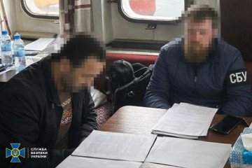 A Security Service of Ukraine (SBU) officer questions the detained foreign captain of a Russian shadow fleet vessel inside a ship’s cabin. (Source: Getty Images)