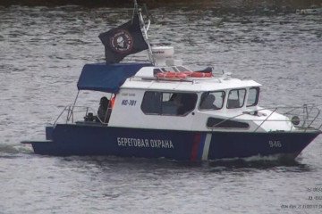 Russian FSB coast guard boat patrols the Narva River near the Estonian border while flying a Wagner Group flag. (Source: Estonian MFA)