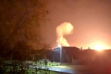 A large explosion and subsequent fire rise above buildings in the Rostov region of Russia during a night drone attack. (Source: Exilenova+)