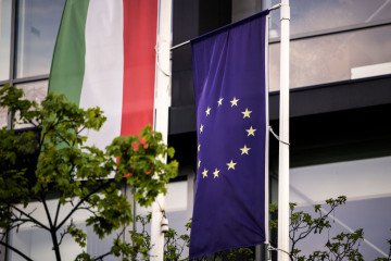 The Hungarian, left, and the European Union flags at the EU Point community center in Budapest, Hungary, on April 19, 2023. (Source: Getty Images)