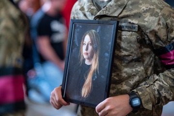 Victoria Roshchyna, Tortured to Death by Russia, and Imprisoned Ukrainian Journalists Receive Human Rights Award A soldier of the honor guard holds a portrait of Victoria Amelina during a funeral service in front of the Saint Peter and Paul Garrison Church on July 5, 2023 in Lviv, Ukraine. (Source: Getty Images)