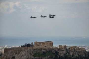 Hellenic Air Force fighter aircrafts Dassault Mirage 2000 fly over the ancient temple of Parthenon atop the Acropolis hill during a military parade marking Greece’s Independence Day in Athens, on March 25, 2026. (Source: Getty Images)
