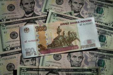 Russian rouble banknotes are seen besides a five Dollar bill notes on March 14, 2026 in Bath, England. (Source: Getty Images)