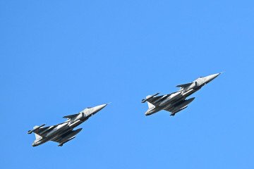 Two Saab JAS 39 Gripen combat aircraft of the Hungarian Air Force flying over the official St. Stephen’s Day ceremony presides over the official St. Stephen’s Day ceremony outside the Hungarian Parliament in Budapest, Hungary. (Source: Getty Images)