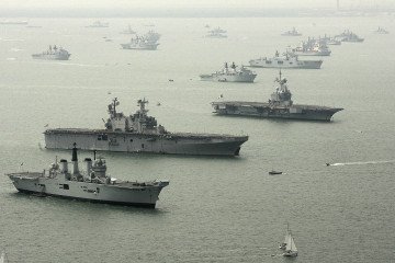 Illustrative image. An aerial view of (L-R) HMS Invincible, USS Saipan, and FS Charles de Gaulle with some of the 112 warships gathered in the Solent ahead of the International Fleet Review on June 26, 2005, in Portsmouth, England. (Source: Getty Images)