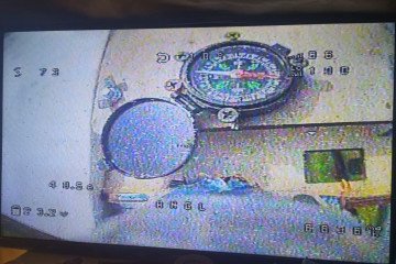 A first-person view from a Russian Molniya drone shows a magnetic compass mounted inside the airframe—a surprisingly analog backup to modern drone navigation. (Source: Serhii "Flash" Beskrestnov/Telegram)