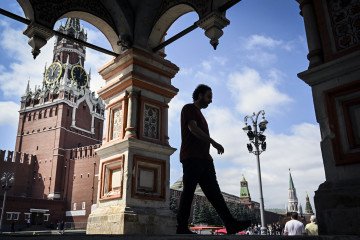 A man walks out of St. Basil's cathedral in front of the Spasskaya tower at Red Square in central Moscow. (Source: Getty Images)