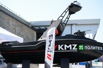 Russian unmanned surface vessel displayed at a defense exhibition, branded with KMZ and Politech logos. (Source: Russian media) Russian unmanned surface vessel displayed at a defense exhibition, branded with KMZ and Politech logos. (Source: Russian media)
