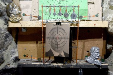 A photograph shows a target with bullet holes, depicting Russian leader Vladimir Putin, in a shooting range in the western Ukrainian city of Lviv, on February 18, 2022. (Source: Getty Images)