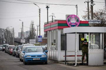A military personnel member from the Transnistria breakaway region of Moldova records the presence of the media at the Varnita crossing point with Moldova, on March 1, 2024. (Source: Getty Images)