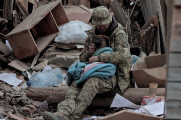 A man with a dog at the site of an air bomb strike in Sloviansk, Donetsk Oblast, on April 15, 2026. (Source: Getty Images/Global Images Ukraine/Yan Dobronosov)