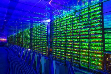 Power Crisis Forces Russia to Abandon 38 Data Center Builds Worth $2.2B Illuminated mining rigs operate inside racks at the CryptoUniverse cryptocurrency mining farm in Nadvoitsy, Russia. (Source: Getty Images)