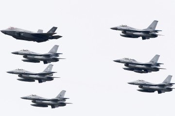 Netherlands' F-35C Lightning II joint striker fighter aircraft fly in formation with F-16 Fighting Falcon aircraft during the Dutch Air Force Days at Leeuwarden Air Base in Leeuwarden on June 10, 2016. (Source: Getty Images)