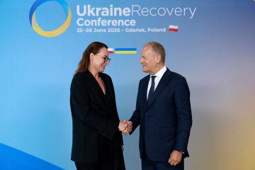 Polish Prime Minister Donald Tusk (R) shakes hands with Ukraine’s Prime Minister Yulia Svyrydenko as she arrives to attend the Ukraine Recovery Conference (URC 2026) in Gdańsk, Poland. (Source: Getty Images)