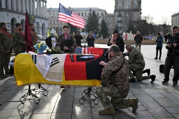 Service members pay tribute next to the coffins of slain South Korean and American volunteer soldiers of the 2nd International Legion in Kyiv, Ukraine, on November 25, 2025. (Source: The Korea Herald)