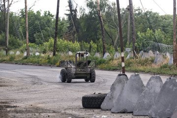 A ground drone travels along a road protected by anti-drone nets in Donetsk region, Ukraine, on June 20, 2026. (Source: Getty Images)