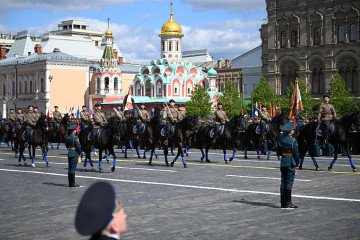 Military history enthusiasts wearing Soviet-era uniforms ride horses on Red Square during the Victory Day military parade in central Moscow on May 9, 2025. (Source: Getty Images)