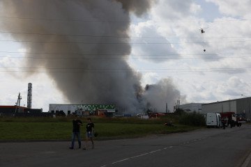 Black smoke rise from a distribution warehouse near Moscow, Russia after Ukraine's drone attack on August 16, 2026. (Source: Getty Images)