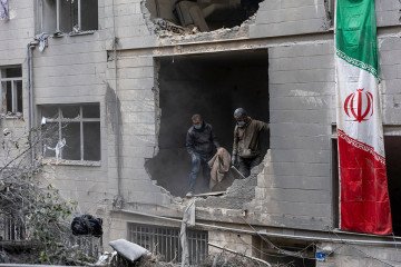 People clear rubble in a house in the Beryanak District after it was damaged by missile attacks two days before, on March 15, 2026 in Tehran, Iran. (Source: Getty Images)