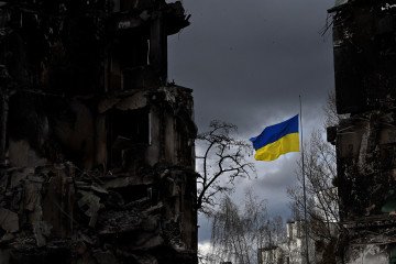 The Ukrainian flag flutters between buildings destroyed in bombardment, in the Ukrainian town of Borodianka, in the Kyiv region, on April 17, 2022. The Ukrainian flag flutters between buildings destroyed in bombardment, in the Ukrainian town of Borodianka, in the Kyiv region, on April 17, 2022.