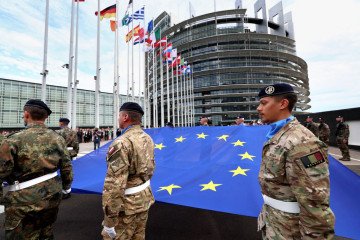 Eurocorps soldiers carry a European Union flag during the flag-raising ceremony in Strasbourg, eastern France. (Source: Getty Images)