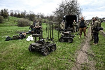 Soldiers stay by ground robotic complexes during trials at a training ground on April 10, 2026. (Source: Getty Images)