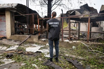 A war crimes prosecutor faces a house damaged by a Russian drone attack in the Odesa region, Ukraine, on May 16, 2025. (Source: Getty Images)