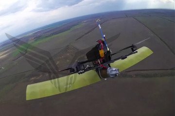 A Ukrainian winged FPV quadcopter captured in the camera feed of a Russian air defense drone from the “Rubikon” unit, April 2026. (Source: @GrandpaRoy2)