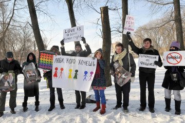 LGBTQ-rights activists hold placards on February 14, 2011 during a rally against homophobia in Minsk, Belarus. (Source: Getty Images)
