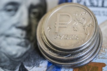 Russian ruble coins on a US dollar note. Illustrative image. (Source: Getty Images)