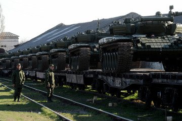 Russian soldiers stand beside a train carrying modified T-72 tanks at Gvardeyskoe station near Simferopol, Crimea, March 31, 2014. Illustrative photo. (Source: Olga Maltseva/AFP via Getty Images)
