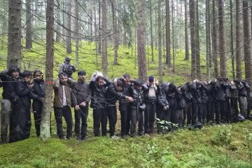 A group of 28 people detained by Latvian border guards after illegally crossing from Belarus into Latvia through an underground tunnel. (Source: Delfi)