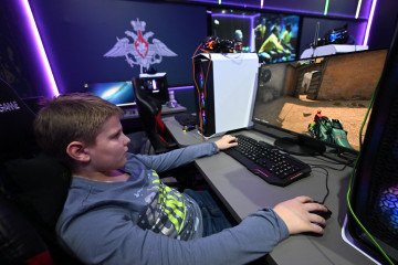 A boy plays a shooter video game inside the Russian Defense Ministry pavilion at Russia Expo, in Moscow on January 24, 2024. (Source: Getty Images) A boy plays a shooter video game inside the Russian Defense Ministry pavilion at Russia Expo, in Moscow on January 24, 2024. (Source: Getty Images)