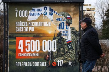 A man walks past an information billboard advertising contract service in the Russian Armed Forces, installed on one of the city streets. (Source: Getty Images) A man walks past an information billboard advertising contract service in the Russian Armed Forces, installed on one of the city streets. (Source: Getty Images)